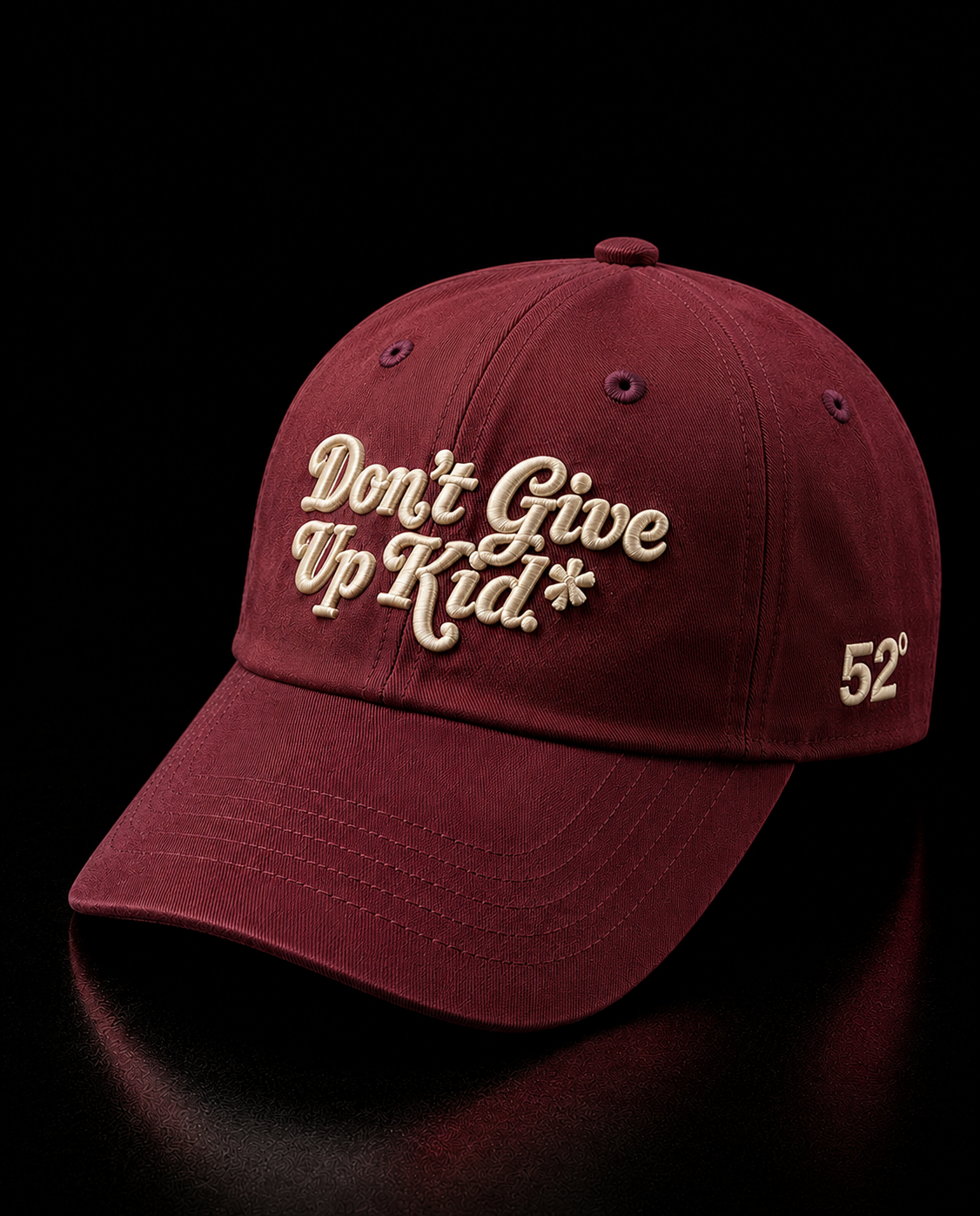 Maroon cap with 'Don't Give Up Kid' text and number 52 on a black background