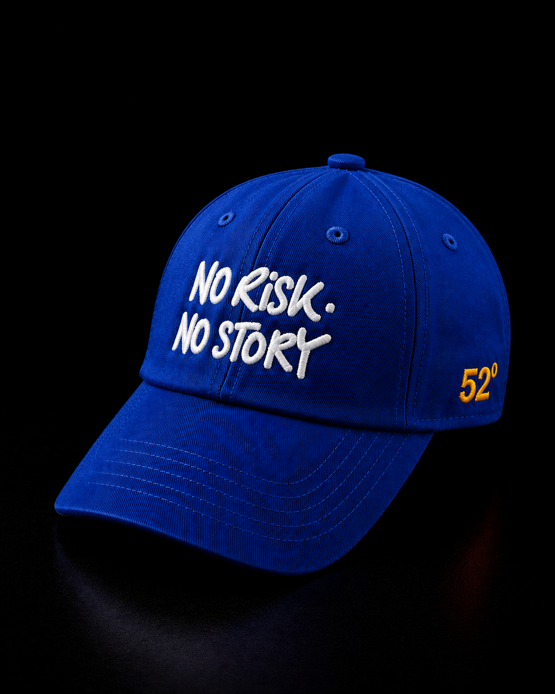 Blue cap with 'No Risk. No Story' text on a black background