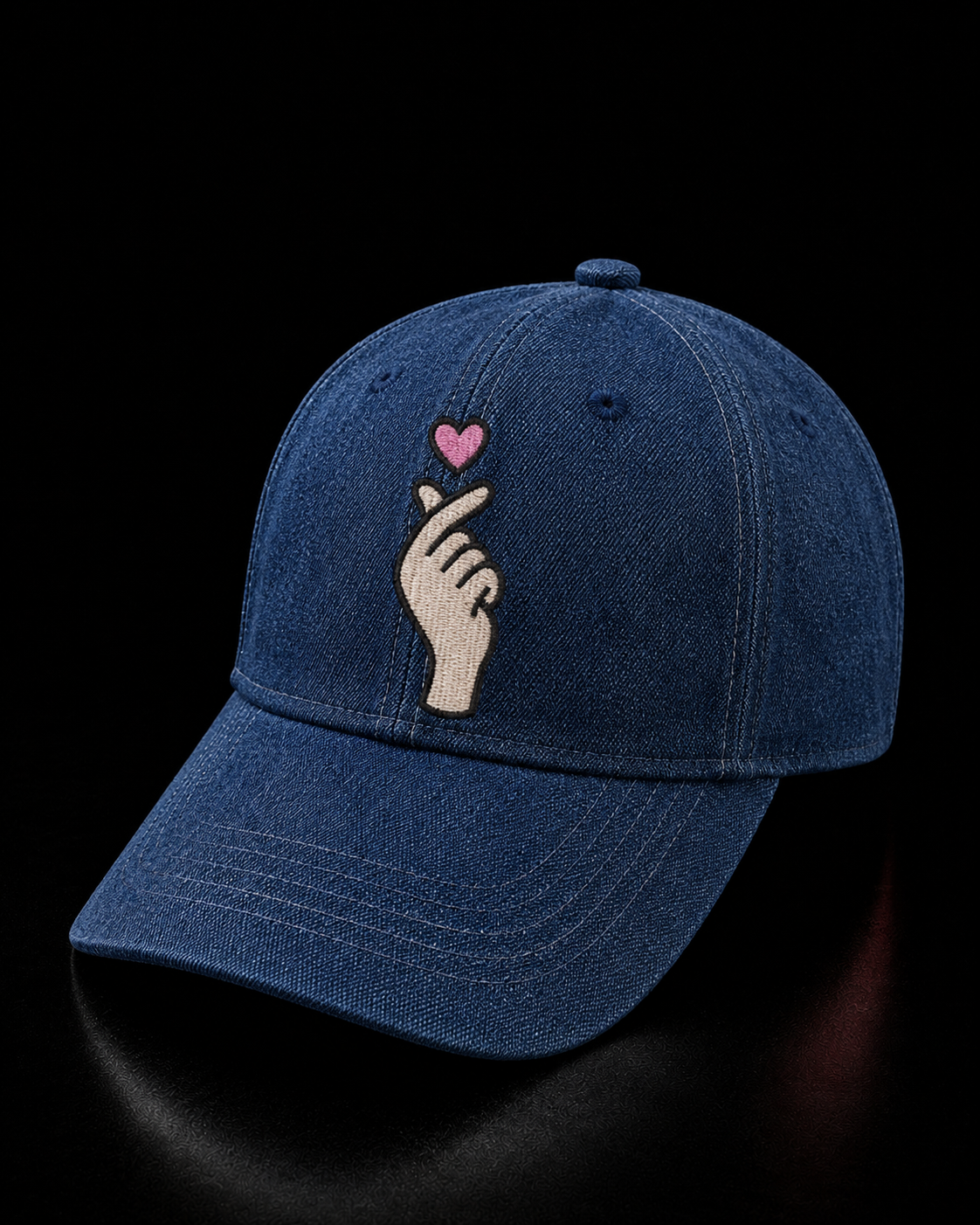 Blue cap with hand and heart design on a black background