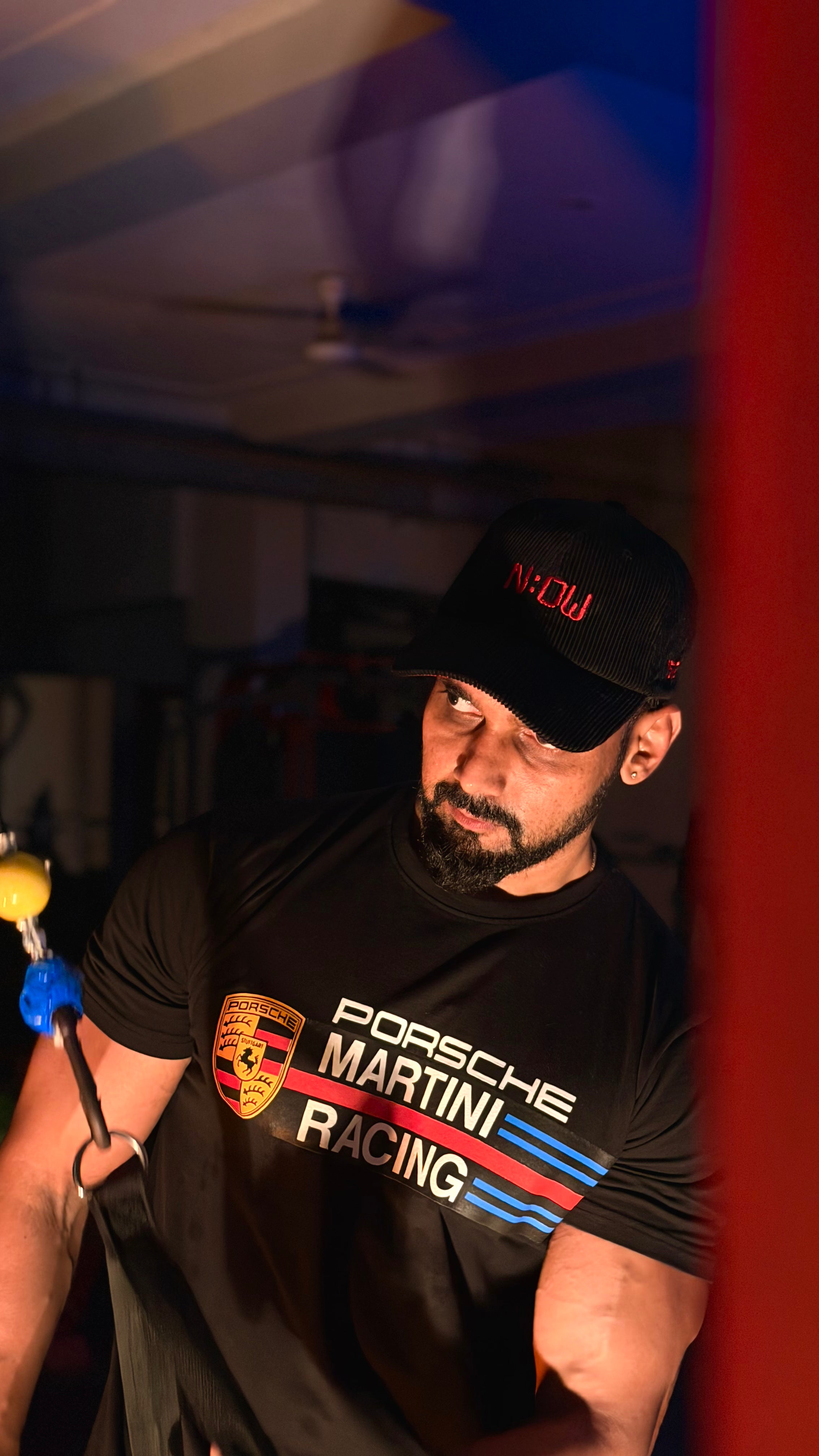 Man wearing a cap in a garage setting