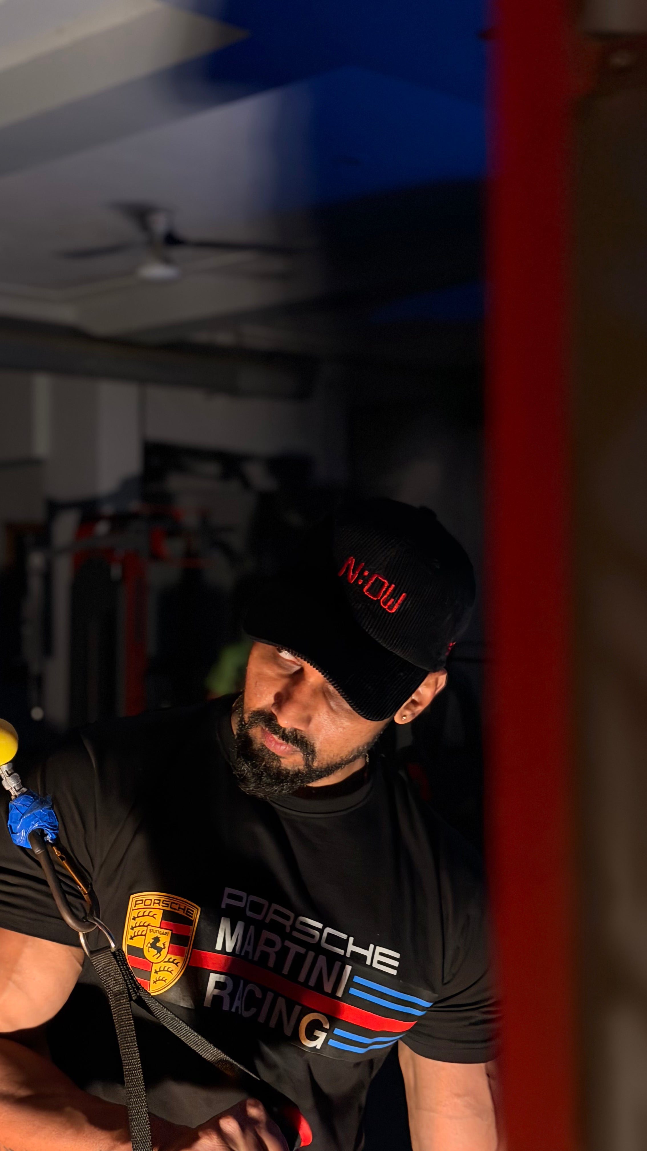 Person wearing a Now cap in a garage setting
