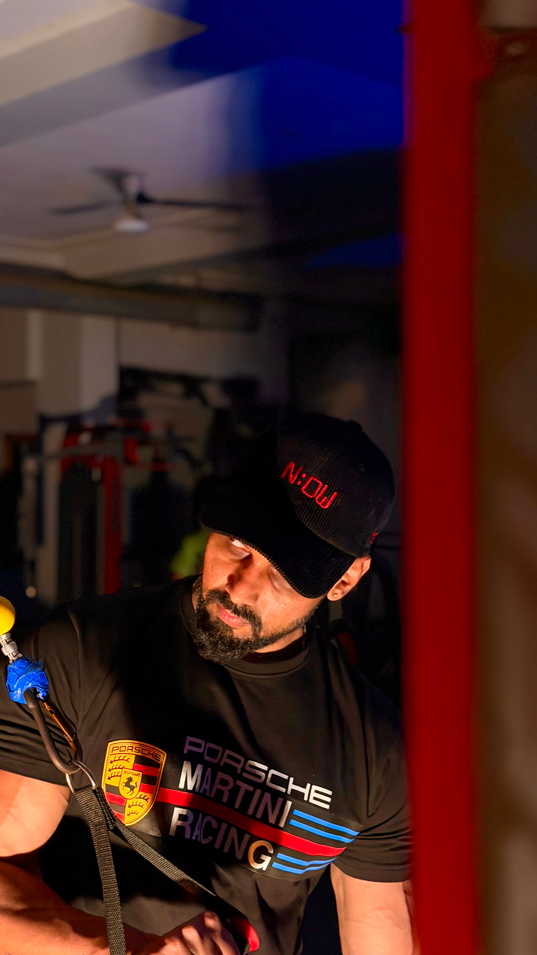 Man wearing a cap in a garage setting